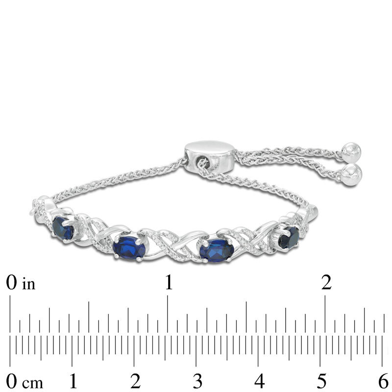 Oval Lab-Created Blue Sapphire and 0.09 CT. T.W. Diamond Infinity Bolo Bracelet in Sterling Silver - 9.5"