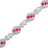 Thumbnail Image 0 of Lab-Created Ruby and 0.23 CT. T.W. Diamond Swirl Three Stone Bracelet in Sterling Silver - 7.5"