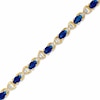 Thumbnail Image 1 of Oval Sapphire and Diamond Accent X Bracelet in 10K Gold - 7.25"