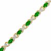 Thumbnail Image 1 of Oval Emerald and Diamond Accent X Bracelet in 10K Gold - 7.25"