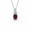 Thumbnail Image 0 of Oval Garnet and White Sapphire Bezel-Set Pendant in 10K White Gold