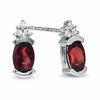 Thumbnail Image 1 of Oval Garnet and White Sapphire Bezel-Set Earrings in 10K White Gold