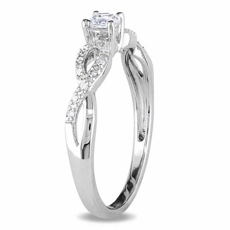 White Lab-Created Sapphire and 0.08 CT. T.W. Diamond Twist Shank Promise Ring in Sterling Silver
