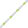 Thumbnail Image 0 of Oval Peridot and 0.10 CT. T.W. Diamond Bracelet in Sterling Silver - 7.5"