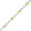 Thumbnail Image 1 of Oval Peridot and 0.10 CT. T.W. Diamond Bracelet in Sterling Silver - 7.5"