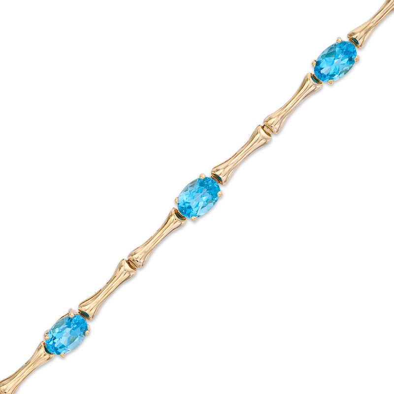 Main Image 1 of Oval Swiss Blue Topaz Bracelet in Sterling Silver with 14K Gold Plate - 7.25"