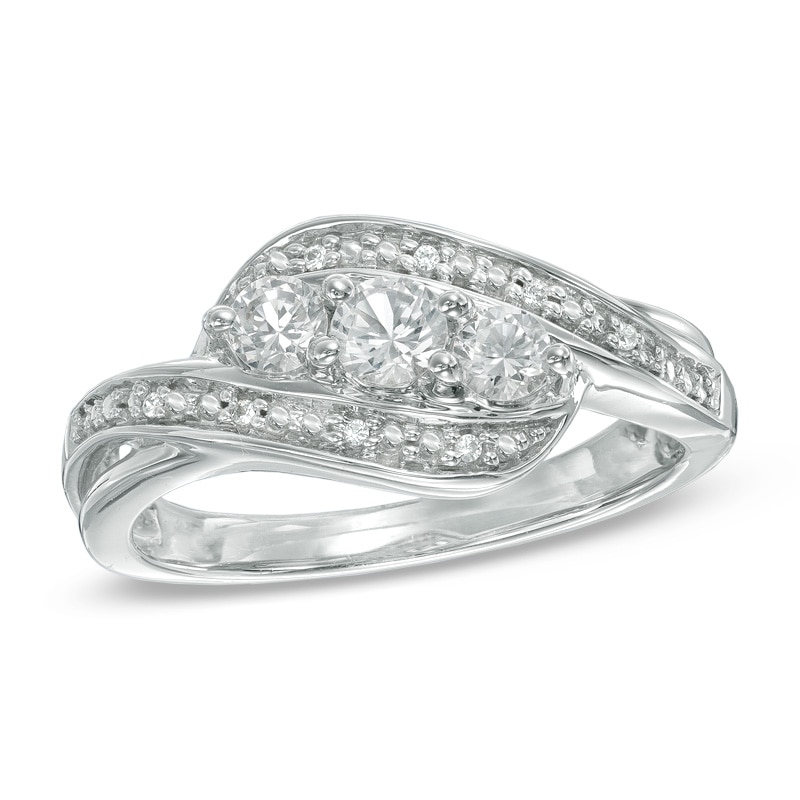 Lab-Created White Sapphire and Diamond Accent Three Stone Ribbon Ring in Sterling Silver