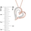 0.15 CT. T.W. Diamond Tilted Ribbon Heart Pendant in 10K Rose Gold