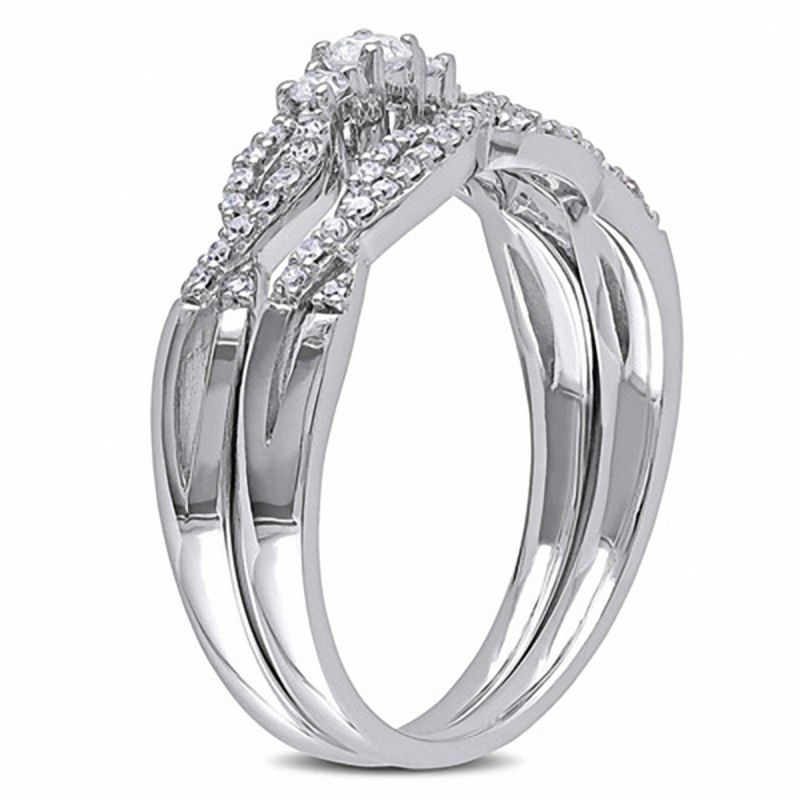 0.31 CT. T.W. Diamond Three Stone Twist Bridal Set in 10K White Gold