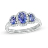 Oval Tanzanite and 0.25 CT. T.W. Diamond Frame Three Stone Ring in 10K White Gold