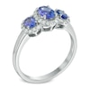 Oval Tanzanite and 0.25 CT. T.W. Diamond Frame Three Stone Ring in 10K White Gold