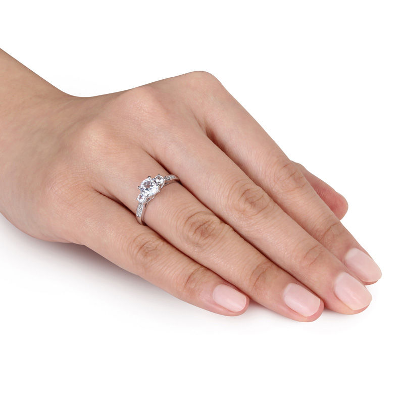 Peoples Jewellers 6.0mm Lab Created White Sapphire and Diamond Accent Three Stone Ring in 10K White Gold Peoples Jewellers Kingsway Mall