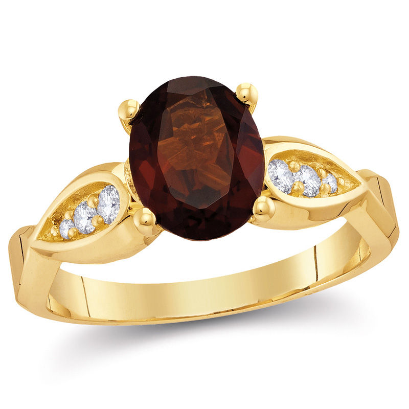 Oval Garnet and 0.11 CT. T.W. Diamond Tri-Sides Ring in 10K Gold