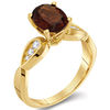 Thumbnail Image 1 of Oval Garnet and 0.11 CT. T.W. Diamond Tri-Sides Ring in 10K Gold