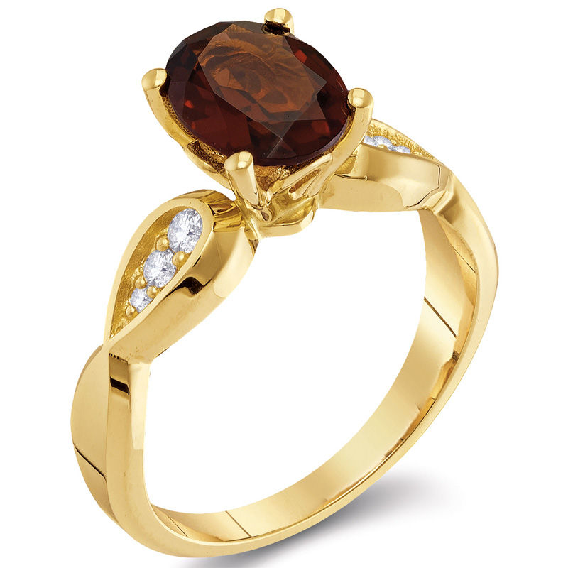 Oval Garnet and 0.11 CT. T.W. Diamond Tri-Sides Ring in 10K Gold