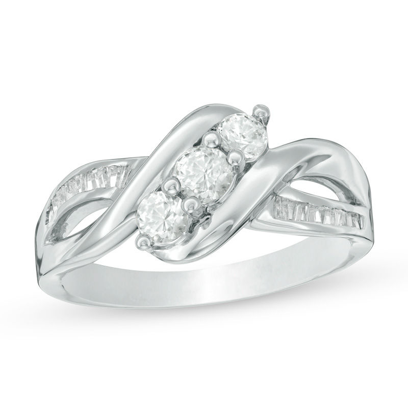 Lab-Created White Sapphire and 0.11 CT. T.W. Baguette Diamond Three Stone Slant Ring in Sterling Silver