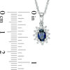 Oval Blue Sapphire and 0.18 CT. T.W. Diamond Starburst Frame Pendant in 10K White Gold