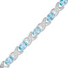 Thumbnail Image 0 of Sideways Oval Swiss Blue Topaz and Diamond Accent "XO" Bracelet in Sterling Silver - 7.25"