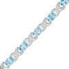 Thumbnail Image 1 of Sideways Oval Swiss Blue Topaz and Diamond Accent "XO" Bracelet in Sterling Silver - 7.25"