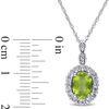 Thumbnail Image 1 of Oval Peridot, White Topaz and Diamond Accent Frame Pendant in 14K White Gold - 17"