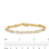3.00 CT. T.W. Baguette and Round Diamond Alternating Flower and Infinity Bracelet in 10K Gold - 7.5"