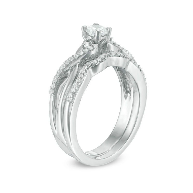 0.29 CT. T.W. Diamond Three Stone Twist Bridal Set in Sterling Silver