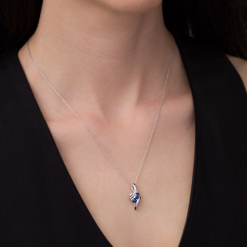 Graduated Lab-Created Blue Sapphire Beaded Swirl Ribbon Three Stone Pendant in Sterling Silver