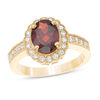 Thumbnail Image 0 of Oval Garnet and 0.34 CT. T.W. Diamond Scallop Frame Vintage-Style Ring in 10K Gold