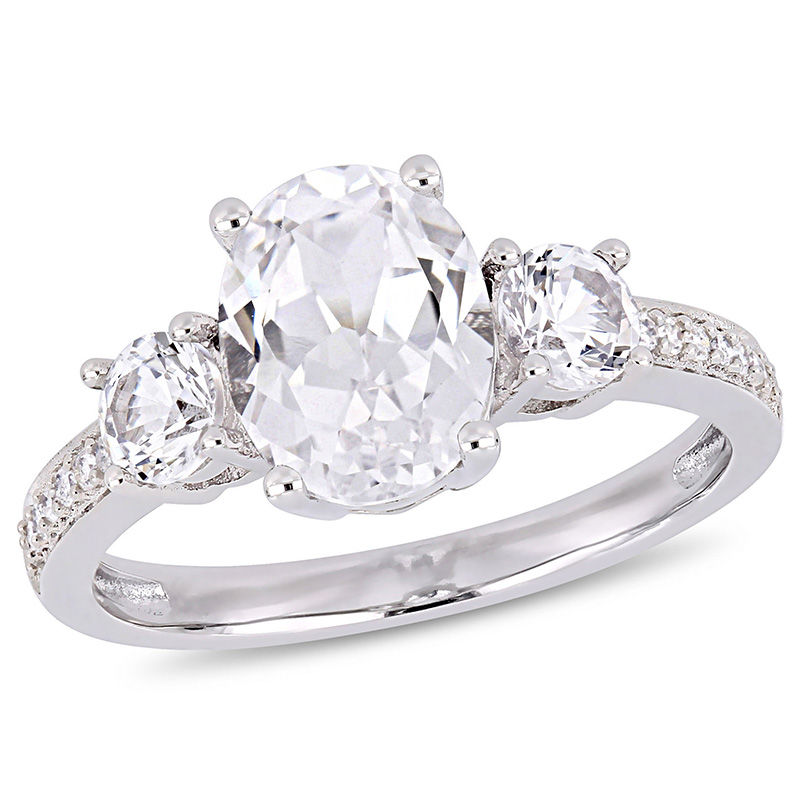 Oval Lab-Created White Sapphire and 0.07 CT. T.W. Diamond Three Stone Engagement Ring in 10K White Gold