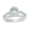 Thumbnail Image 1 of Oval Aquamarine and 0.21 CT. T.W. Diamond Frame Vintage-Style Bridal Set in 10K White Gold