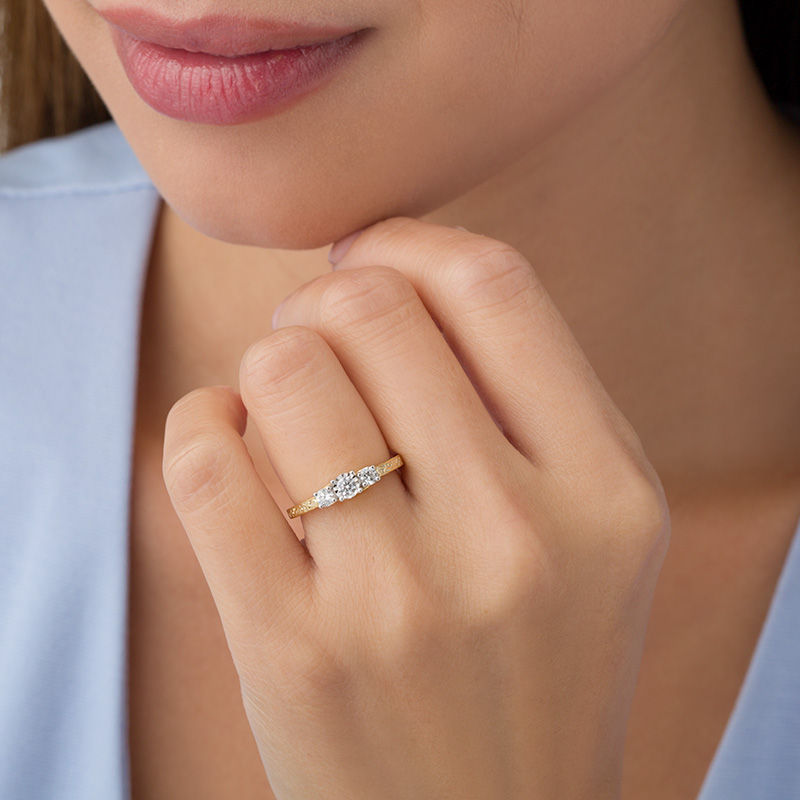 CT. T.W. Diamond Three Stone Filigree Scroll Engagement Ring in 10K Gold