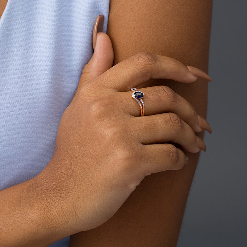 Main Image 2 of Oval Lab-Created Blue Sapphire and 0.065 CT. T.W. Diamond Swirling Bypass Split Shank Promise Ring in 10K Rose Gold