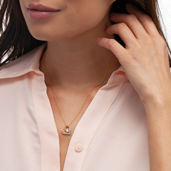 0.065 CT. T.W. Diamond Flower and Heart Outline Pendant in 10K Gold