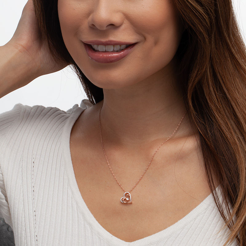 Main Image 2 of 0.085 CT. T.W. Diamond Tilted Layered Double Heart Pendant in 10K Rose Gold