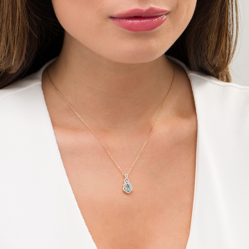 Pear-Shaped Swiss Blue Topaz and 0.15 CT. T.W. Diamond Scallop Frame Ornate Pendant in 10K Gold