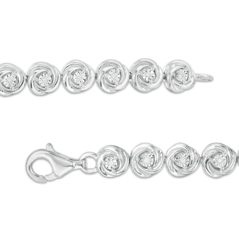 0.086 CT. T.W. Diamond Love Knot Tennis Bracelet in Sterling Silver - 7.5"