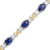 Thumbnail Image 1 of Oval Lab-Created Blue Sapphire and 0.086 CT. T.W. Diamond "X" Bracelet in Sterling Silver and 14K Gold Plate - 7.25"