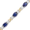 Thumbnail Image 0 of Oval Lab-Created Blue Sapphire and 0.086 CT. T.W. Diamond "X" Bracelet in Sterling Silver and 14K Gold Plate - 7.25"