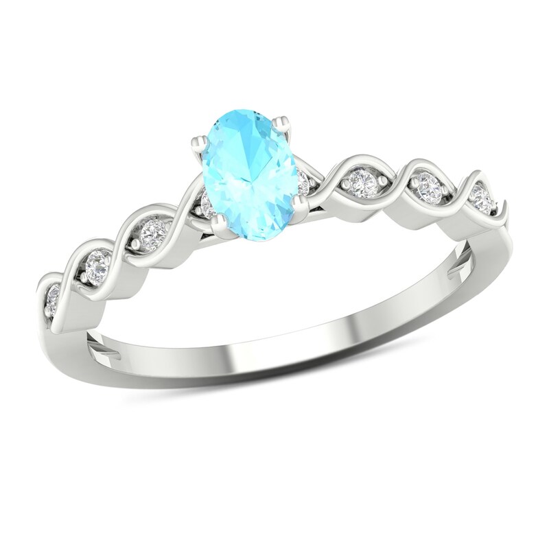 Oval Aquamarine and 0.07 CT. T.W. Diamond Cascading Ribbon Shank Ring in 10K White Gold