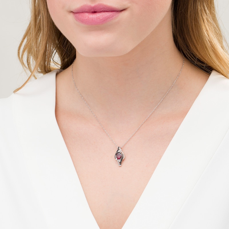 Oval Garnet and 0.085 CT. T.W. White and Black Diamond Bypass Frame Pendant in Sterling Silver