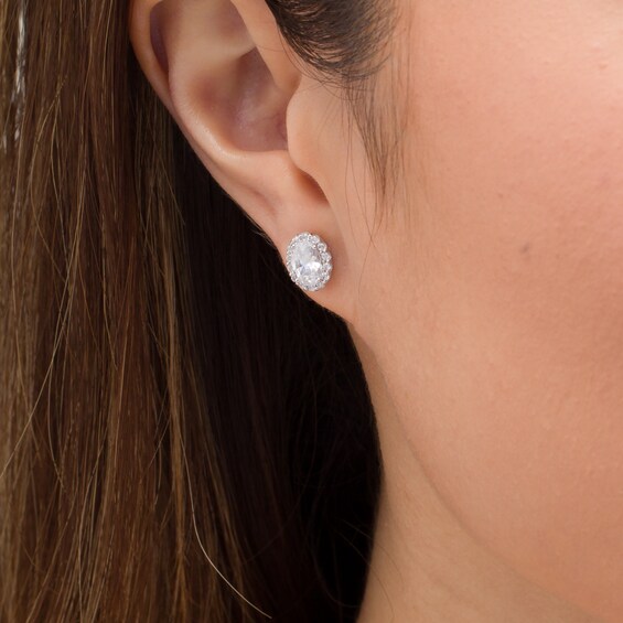 CT. T.W. Certified Oval Diamond Frame Stud Earrings in 14K White Gold (I/SI2