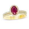 Thumbnail Image 1 of Oval Ruby and 0.33 CT. T.W. Diamond Frame Bridal Set in 14K Gold