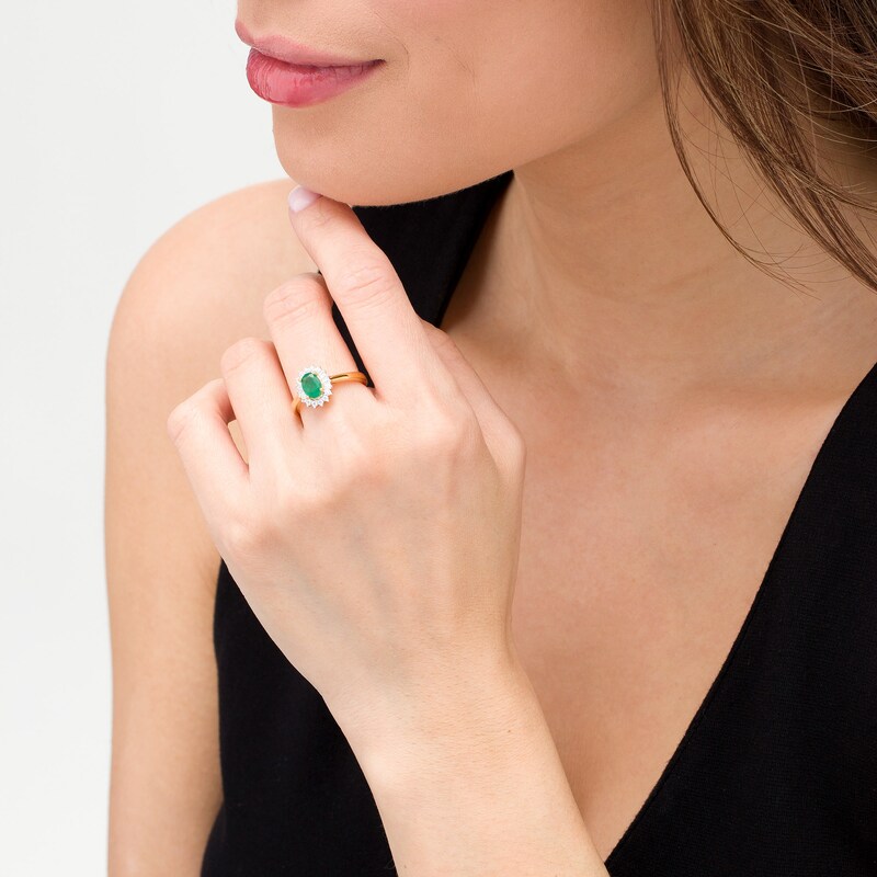 Oval Emerald and 0.20 CT. T.W. Baguette and Round Diamond Starburst Frame Ring in 10K Gold