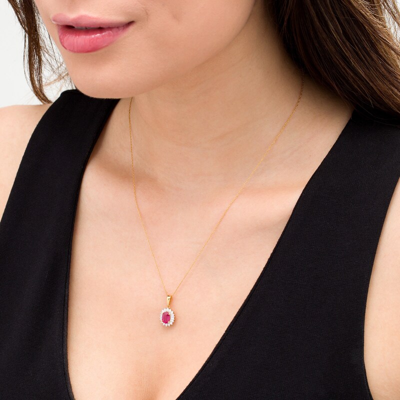 Oval Ruby and 0.20 CT. T.W. Baguette and Round Diamond Starburst Frame Pendant in 10K Gold|Peoples Jewellers