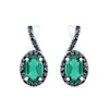 Thumbnail Image 1 of Oval Lab-Created Emerald and 0.085 CT. T.W. Black Enhanced Diamond Frame Twist Drop Earrings in Sterling Silver