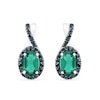 Thumbnail Image 0 of Oval Lab-Created Emerald and 0.085 CT. T.W. Black Enhanced Diamond Frame Twist Drop Earrings in Sterling Silver