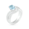 Oval Aquamarine and 0.086 CT. T.W. Diamond Bypass Split Shank Bridal Set in Sterling Silver