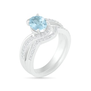 Oval Aquamarine and 0.086 CT. T.W. Diamond Bypass Split Shank Bridal Set in Sterling Silver