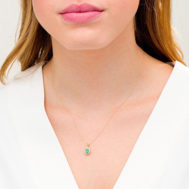 Main Image 2 of Oval Emerald and 0.08 CT. T.W. Diamond Frame Twist Drop Pendant in 10K Gold