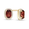 Thumbnail Image 0 of Oval Garnet and 0.088 CT. T.W. Diamond Frame Stud Earrings in 10K Gold